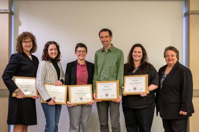 Image of 6 people holding awards and smiling. From left to right the people are Doctors Krueger, Belfi, Kueny, Burns, Henslee, and Murray.